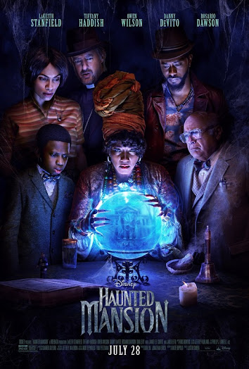 Haunted Mansion movie poster. The main characters stand around a seance table looking at a crystal ball.